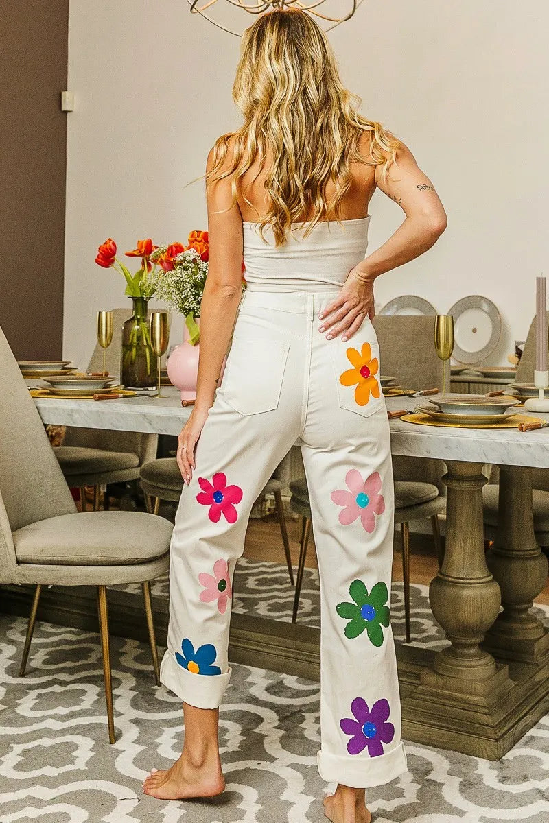 Flower print straight leg pants with pockets and applique.