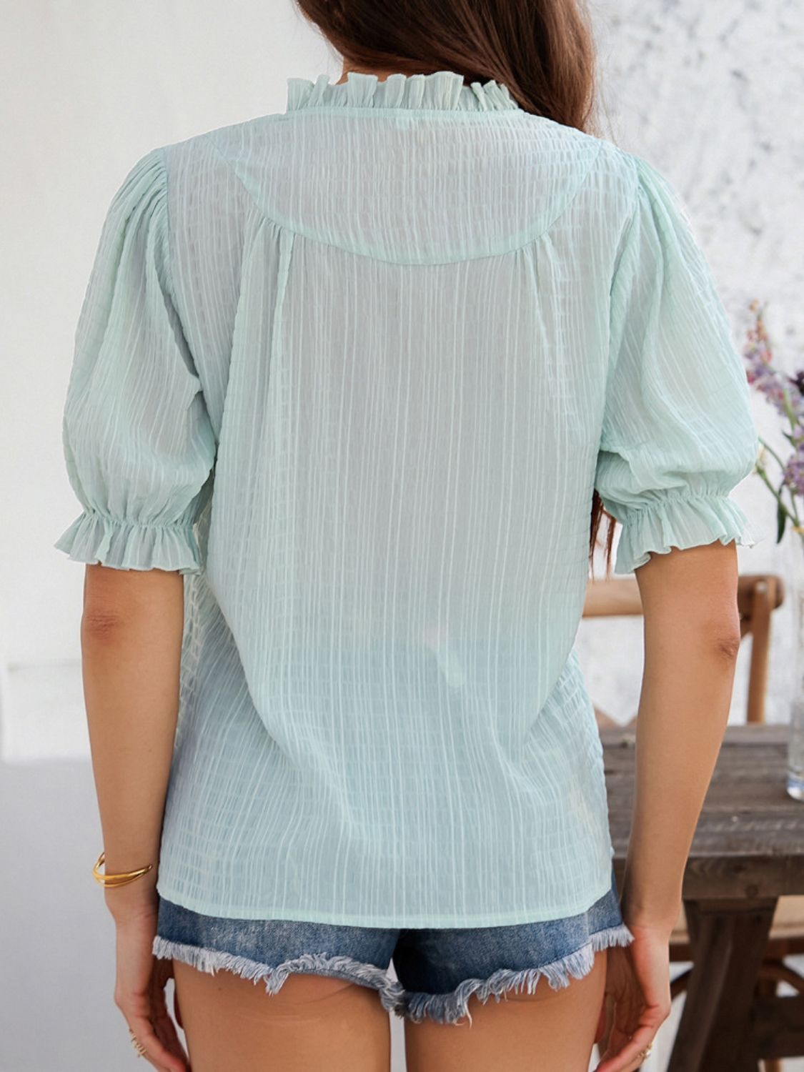 Devine frill notched short sleeve blouse.