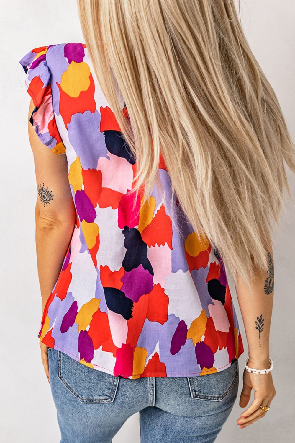 Frill printed mock neck cap sleeve blouse.