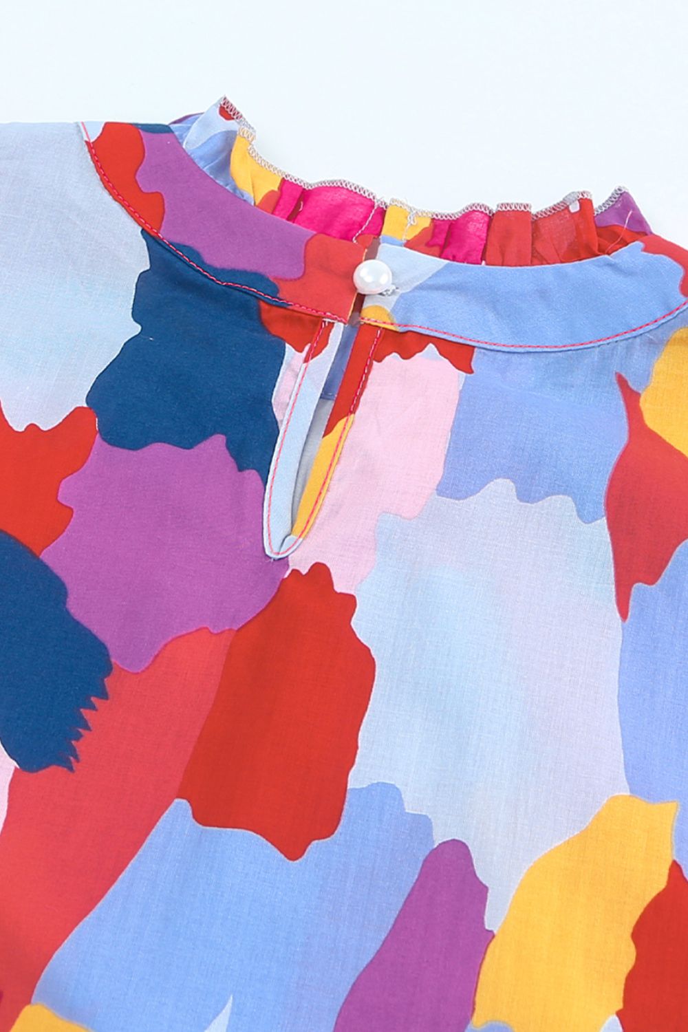 Frill printed mock neck cap sleeve blouse.