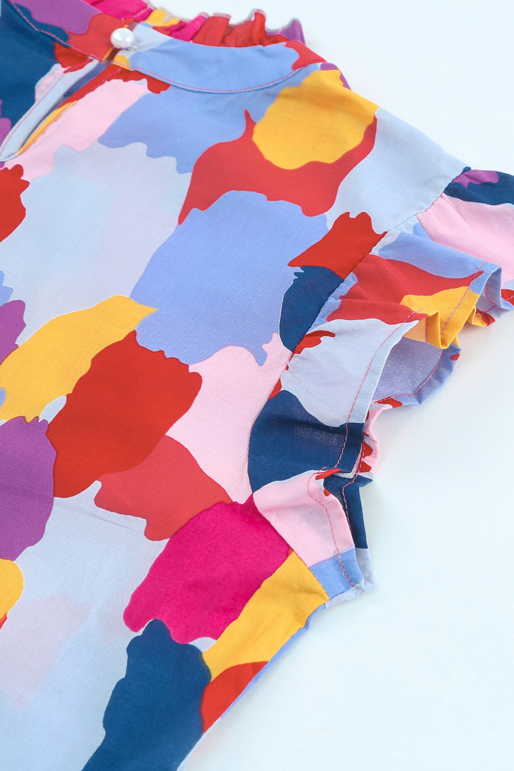 Frill printed mock neck cap sleeve blouse.