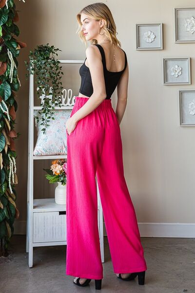 Plus size front tie pants with paperbag waistband and pockets, opaque.