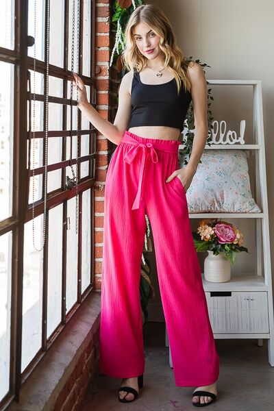 Plus size front tie pants with paperbag waistband and pockets, opaque.