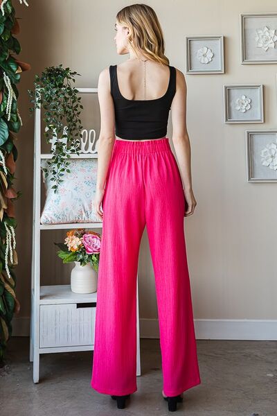 Plus size front tie pants with paperbag waistband and pockets, opaque.