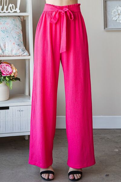 Plus size front tie pants with paperbag waistband and pockets, opaque.