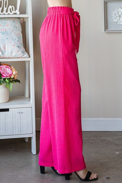 Plus size front tie pants with paperbag waistband and pockets, opaque.