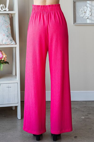 Plus size front tie pants with paperbag waistband and pockets, opaque.