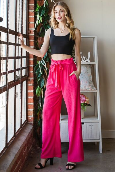 Plus size front tie pants with paperbag waistband and pockets, opaque.