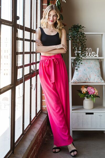 Plus size front tie pants with paperbag waistband and pockets, opaque.