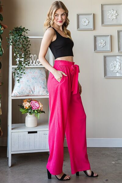 Plus size front tie pants with paperbag waistband and pockets, opaque.
