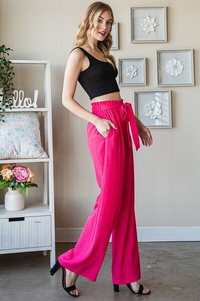 Plus size front tie pants with paperbag waistband and pockets, opaque.