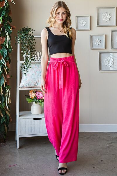 Plus size front tie pants with paperbag waistband and pockets, opaque.