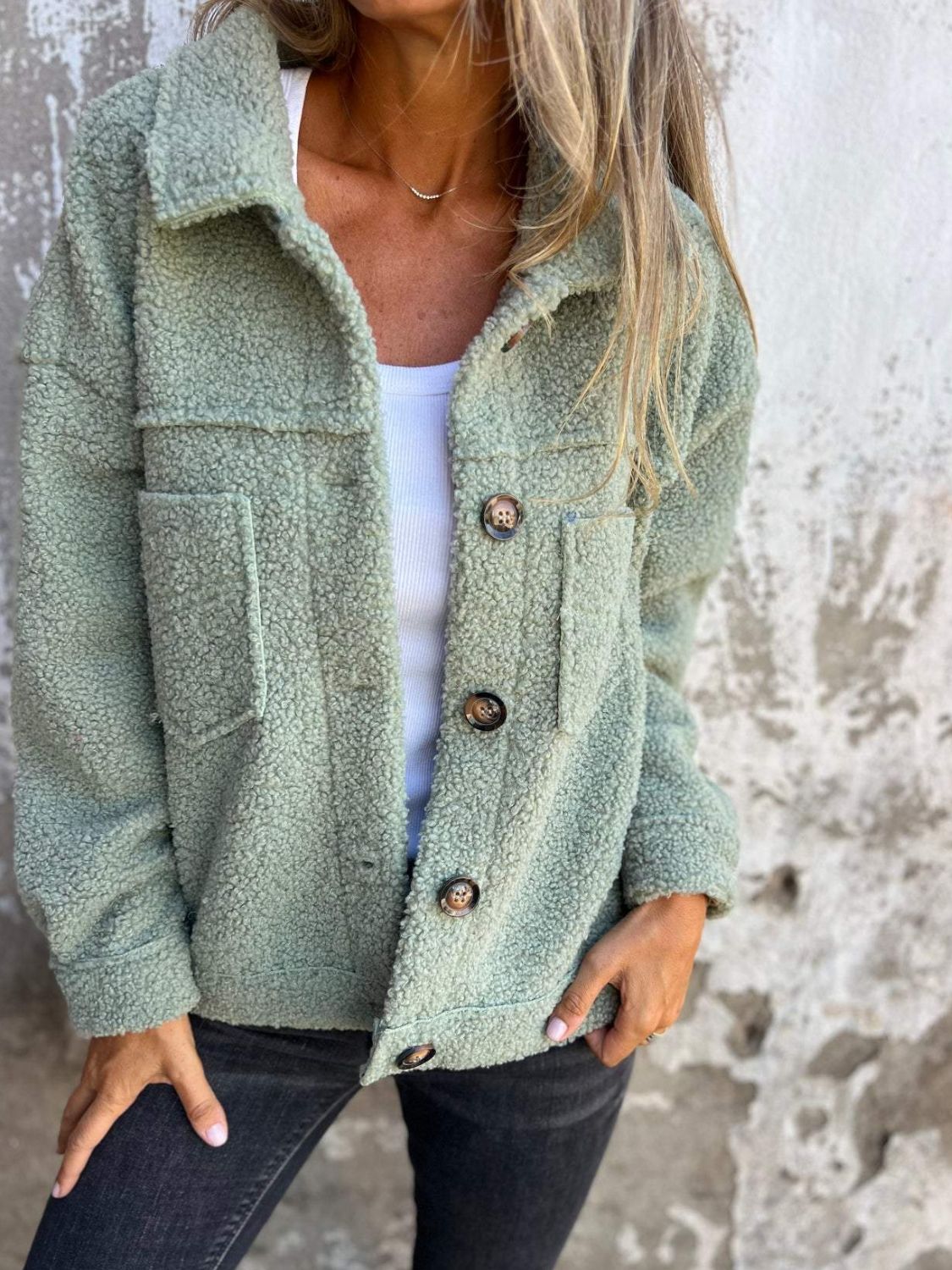 Full size fuzzy button up drop shoulder jacket with pockets.