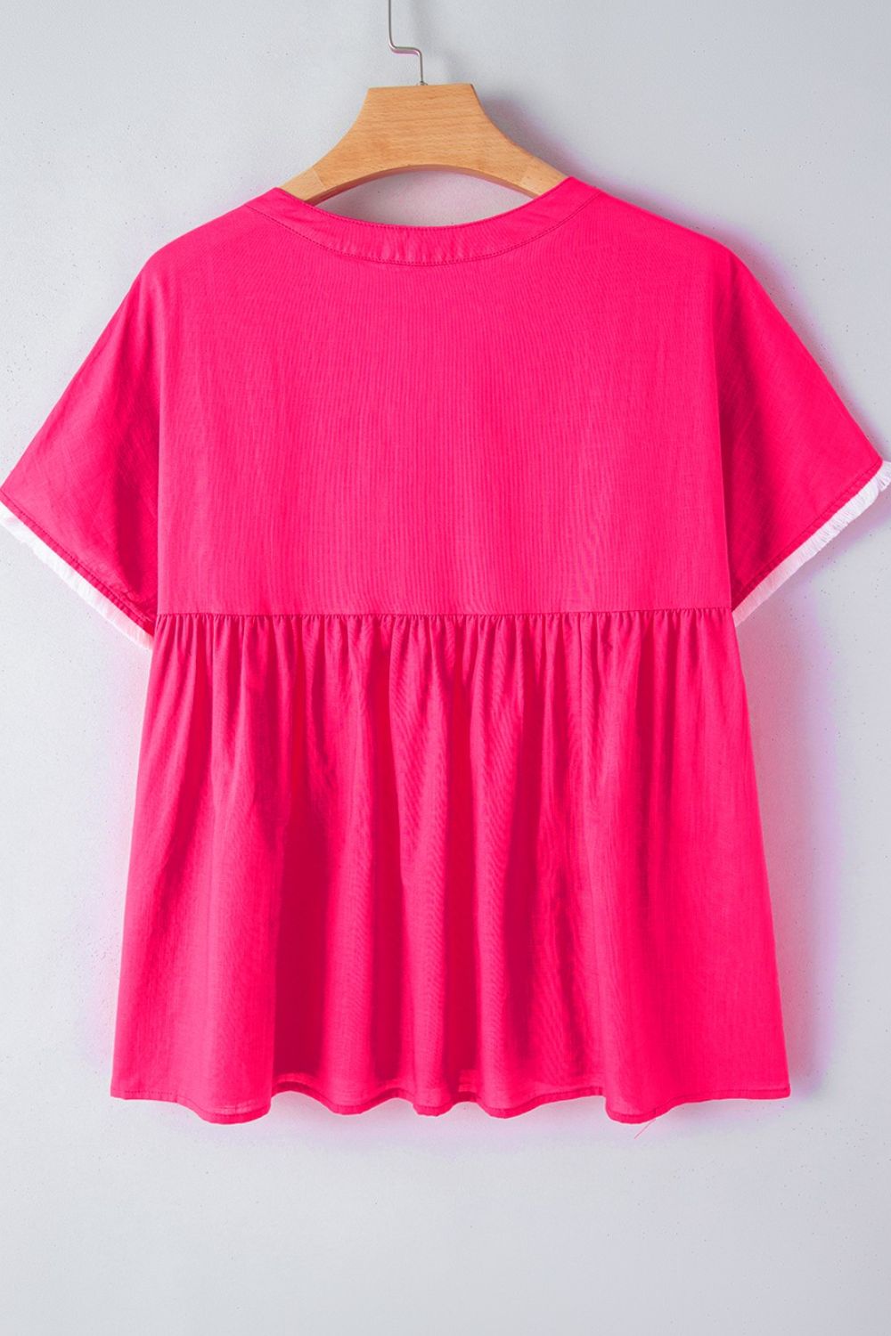 Geometric embroidered tassel tie neck blouse.