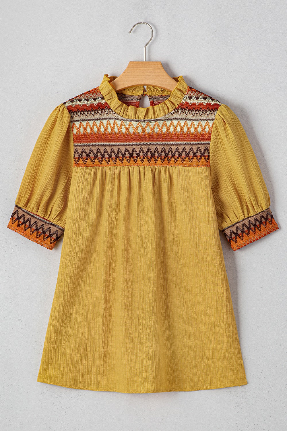Geometric frill mock neck short sleeve blouse.