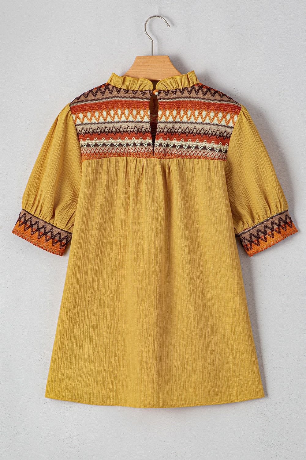 Geometric frill mock neck short sleeve blouse.