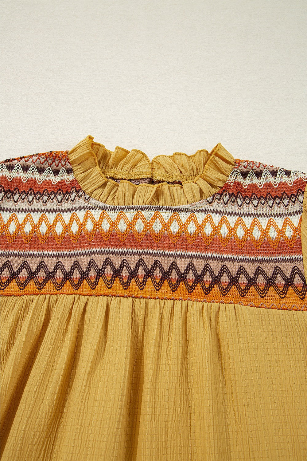 Geometric frill mock neck short sleeve blouse.