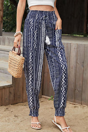 Geometric print tassel high-rise pants with smocked pockets, boho style.