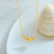 Gold-plated titanium steel necklace featuring a delicate fine chain and polished bow pendant with a graceful, feminine silhouette.