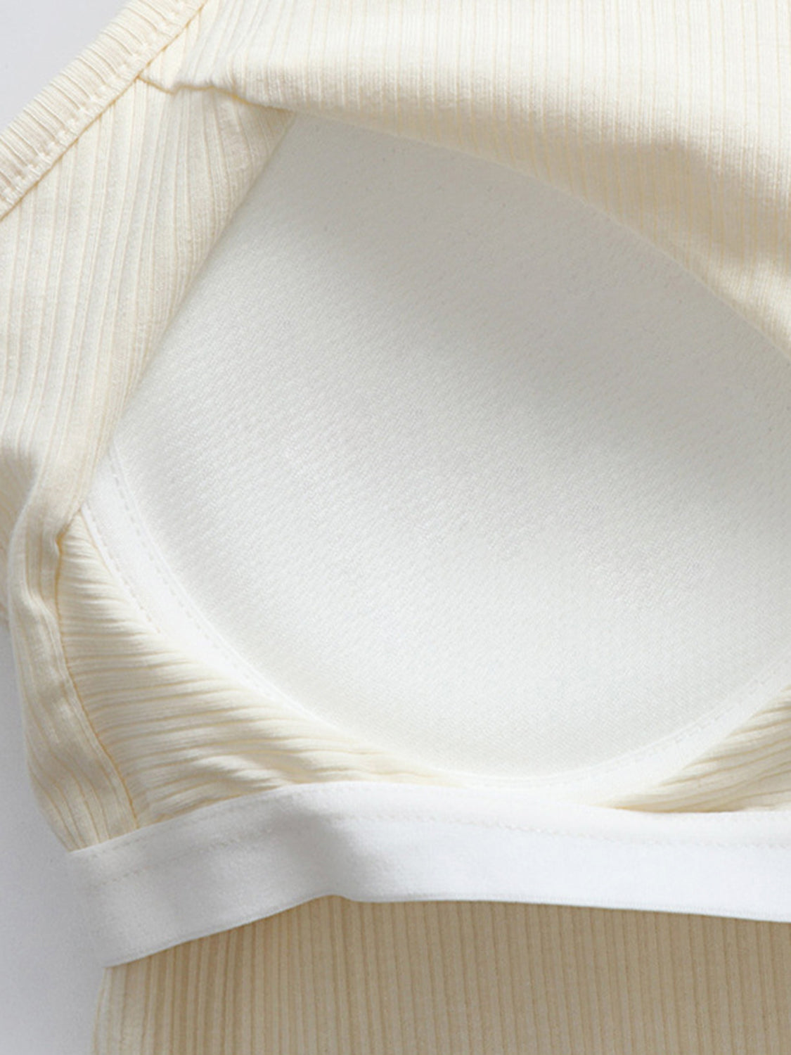 Grecian neck cropped tank top with chest pads.