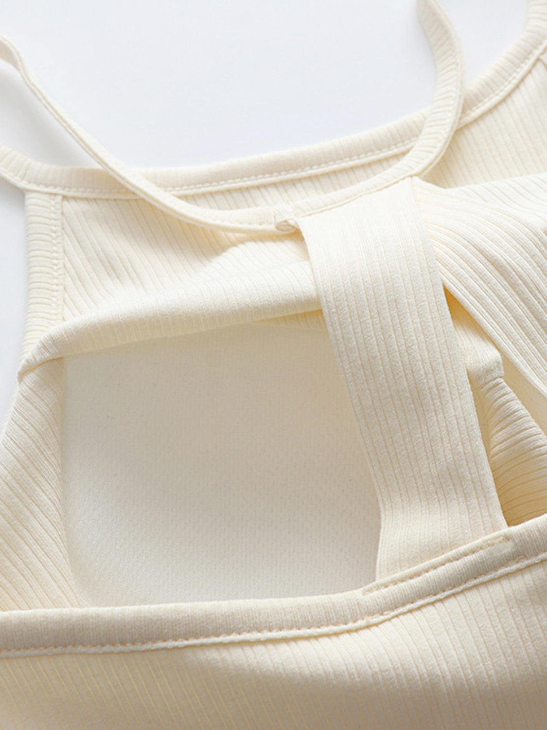 Grecian neck cropped tank top with chest pads.