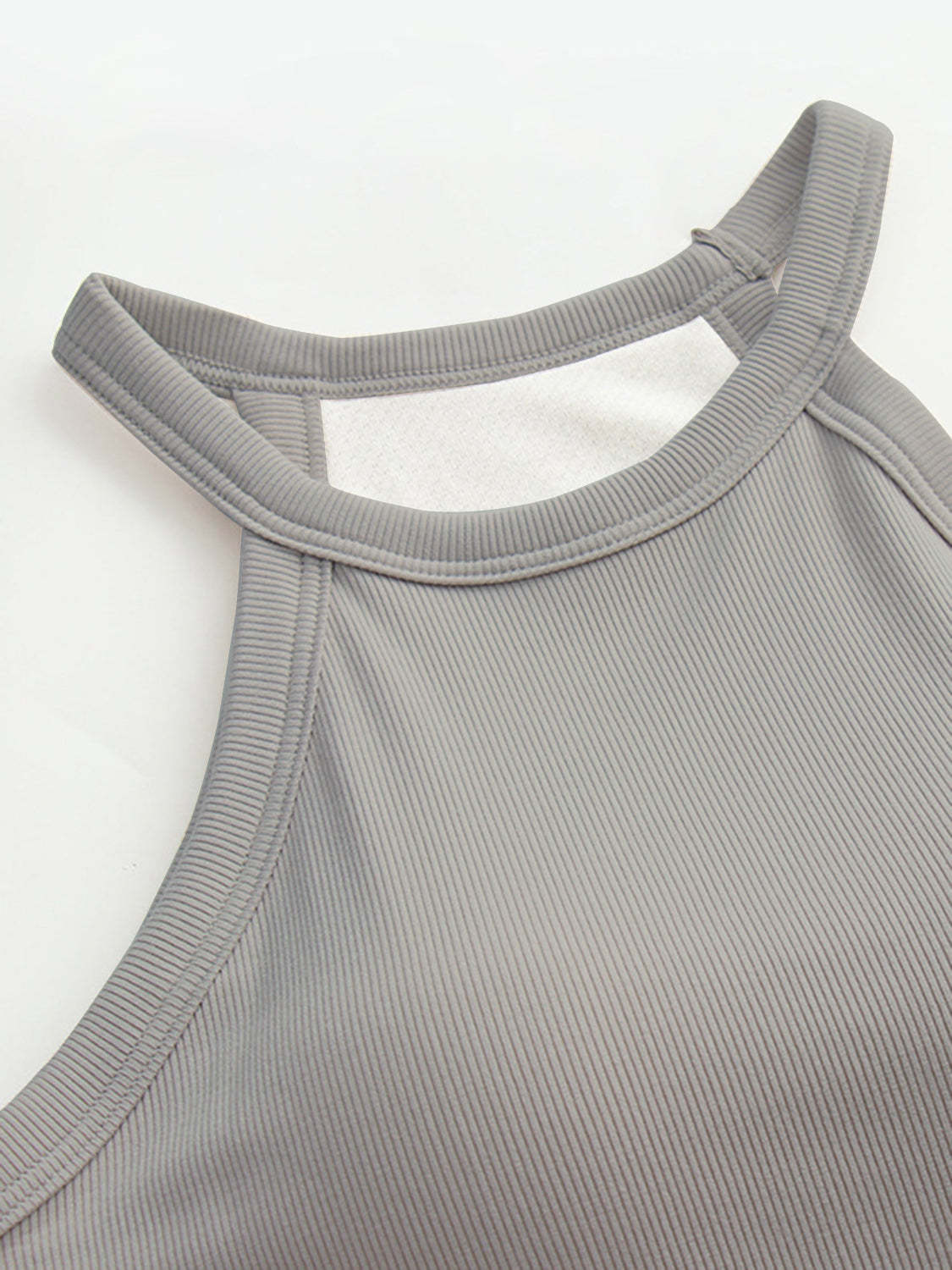 Grecian neck tank top with chest pads.