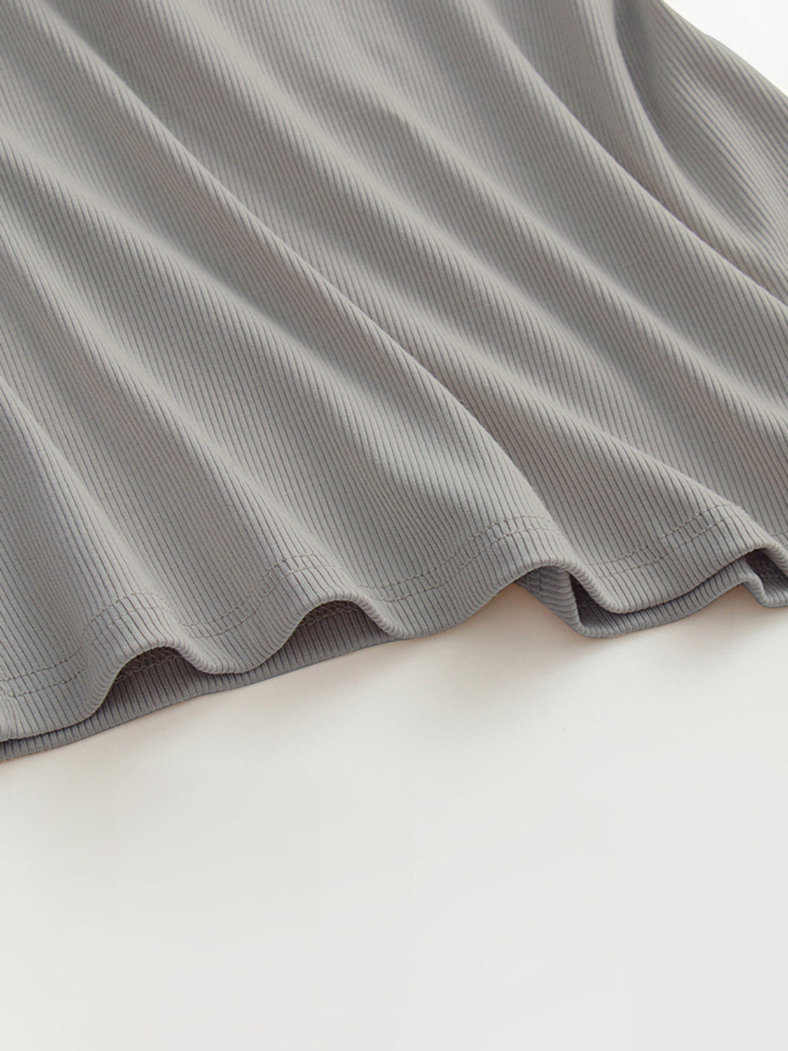 Grecian neck tank top with chest pads.