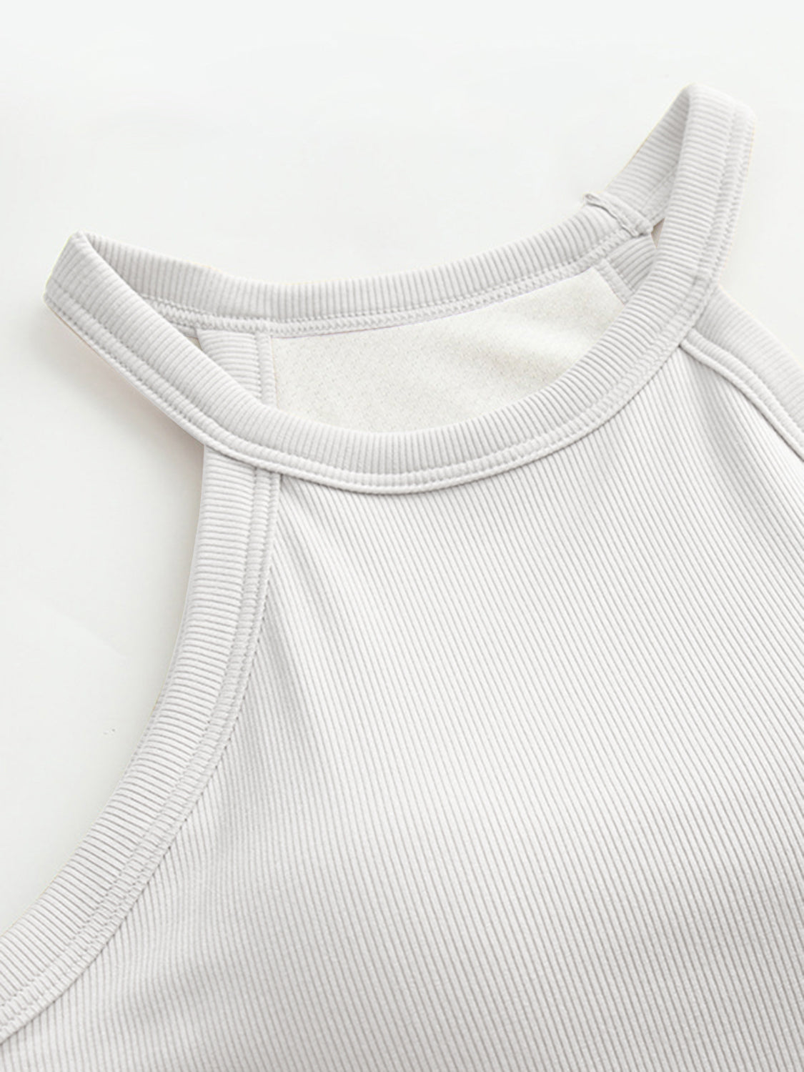 Grecian neck tank top with chest pads.