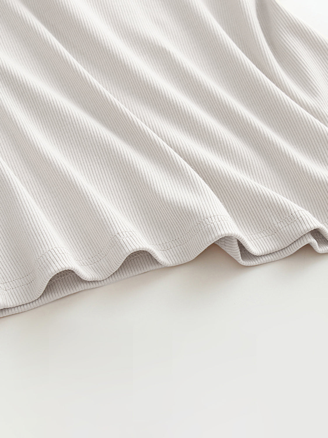 Grecian neck tank top with chest pads.