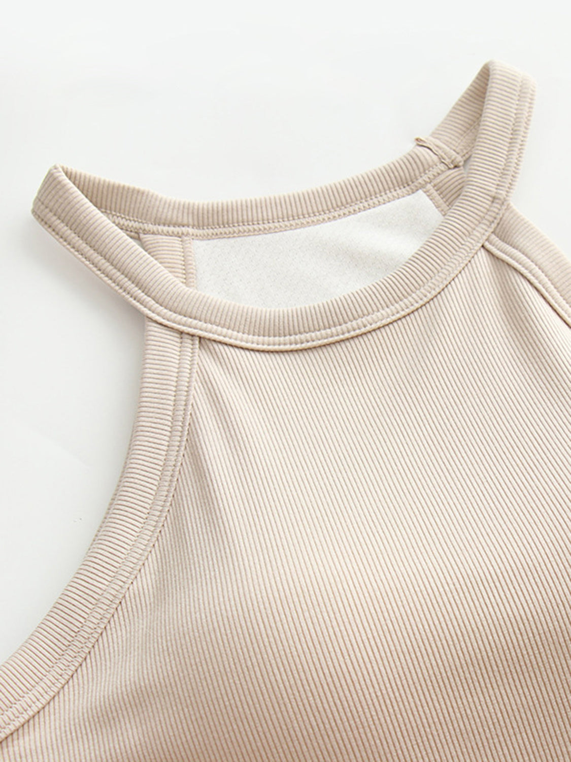 Grecian neck tank top with chest pads.