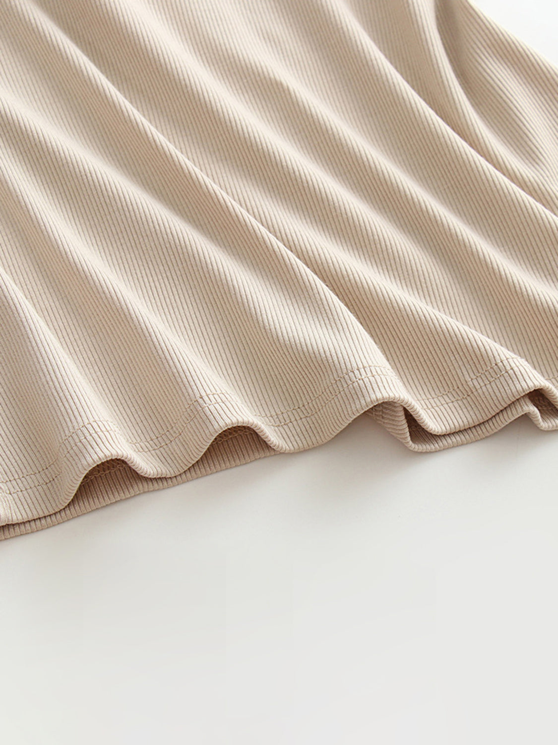 Grecian neck tank top with chest pads.