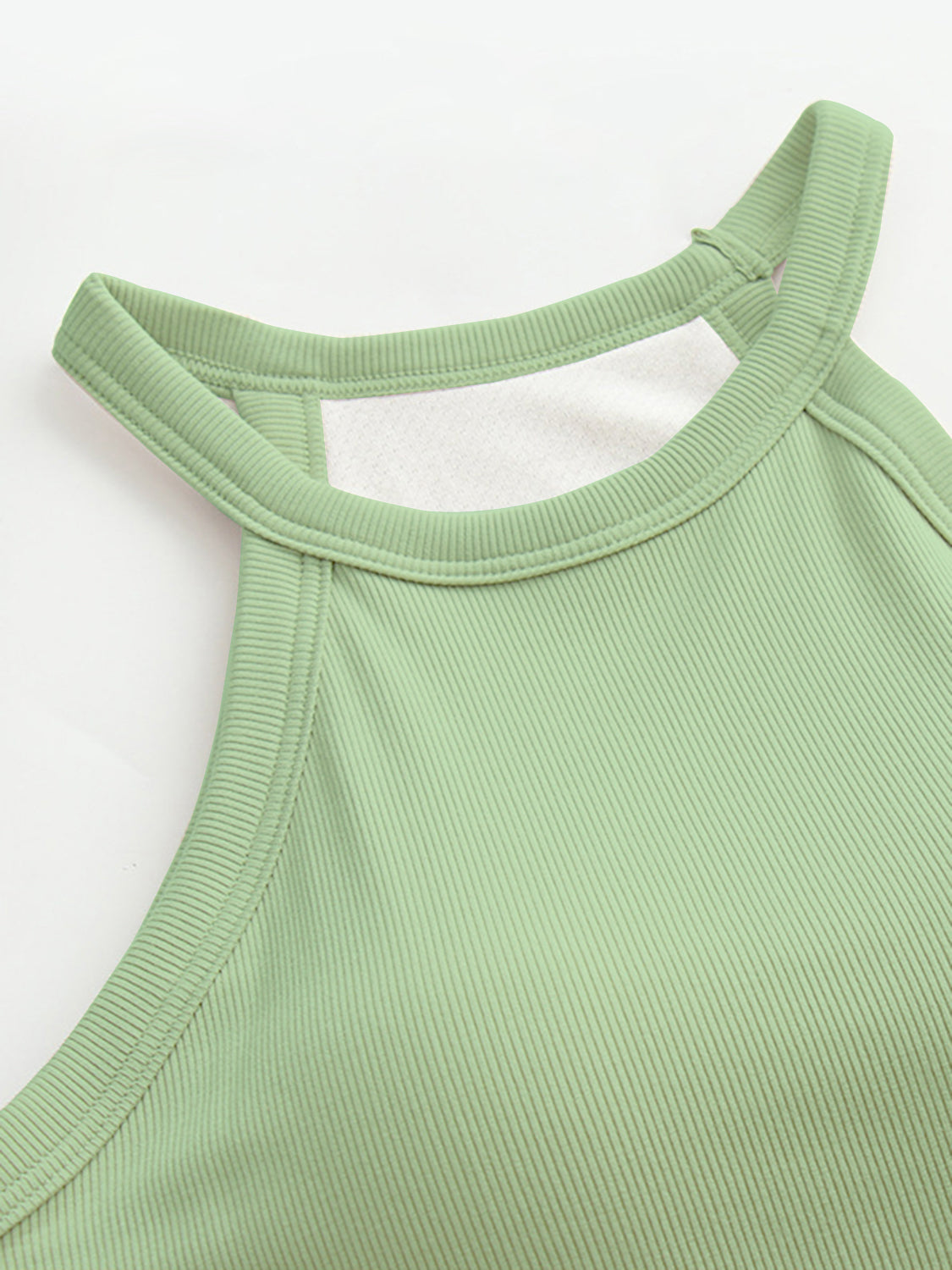 Grecian neck tank top with chest pads.