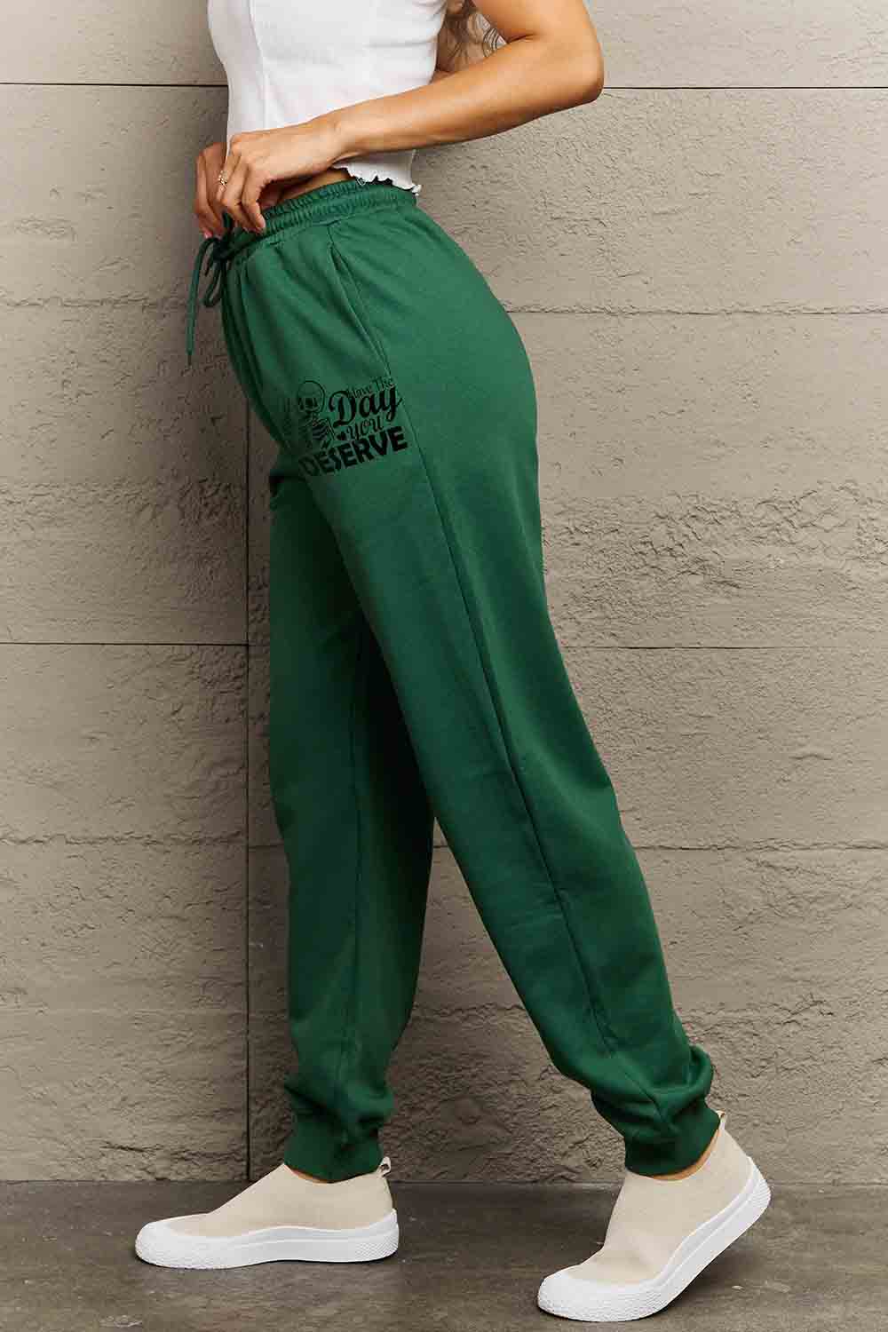 HAVE THE DAY YOU DESERVE graphic sweatpants with drawstring.
