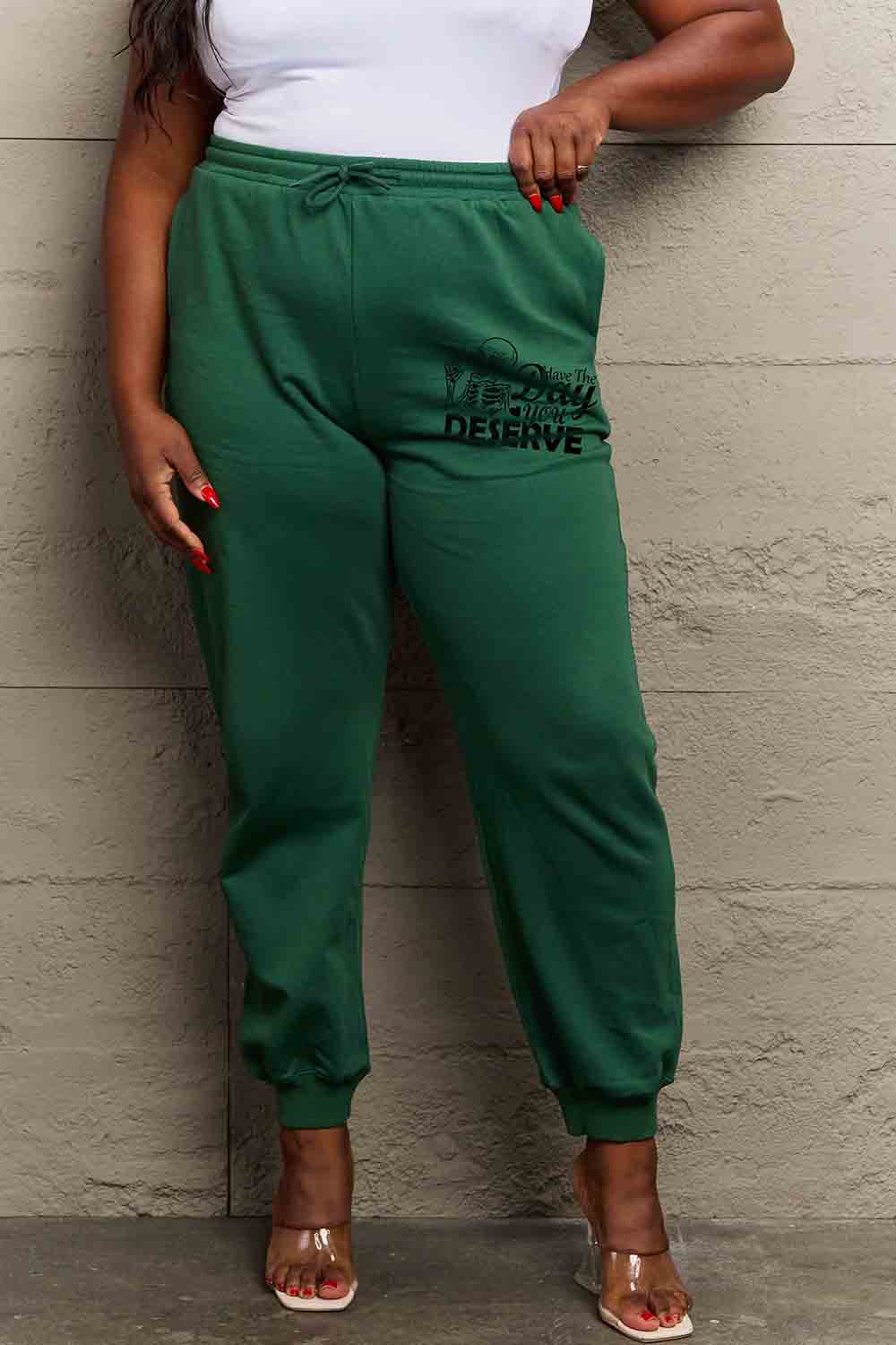 HAVE THE DAY YOU DESERVE graphic sweatpants with drawstring.