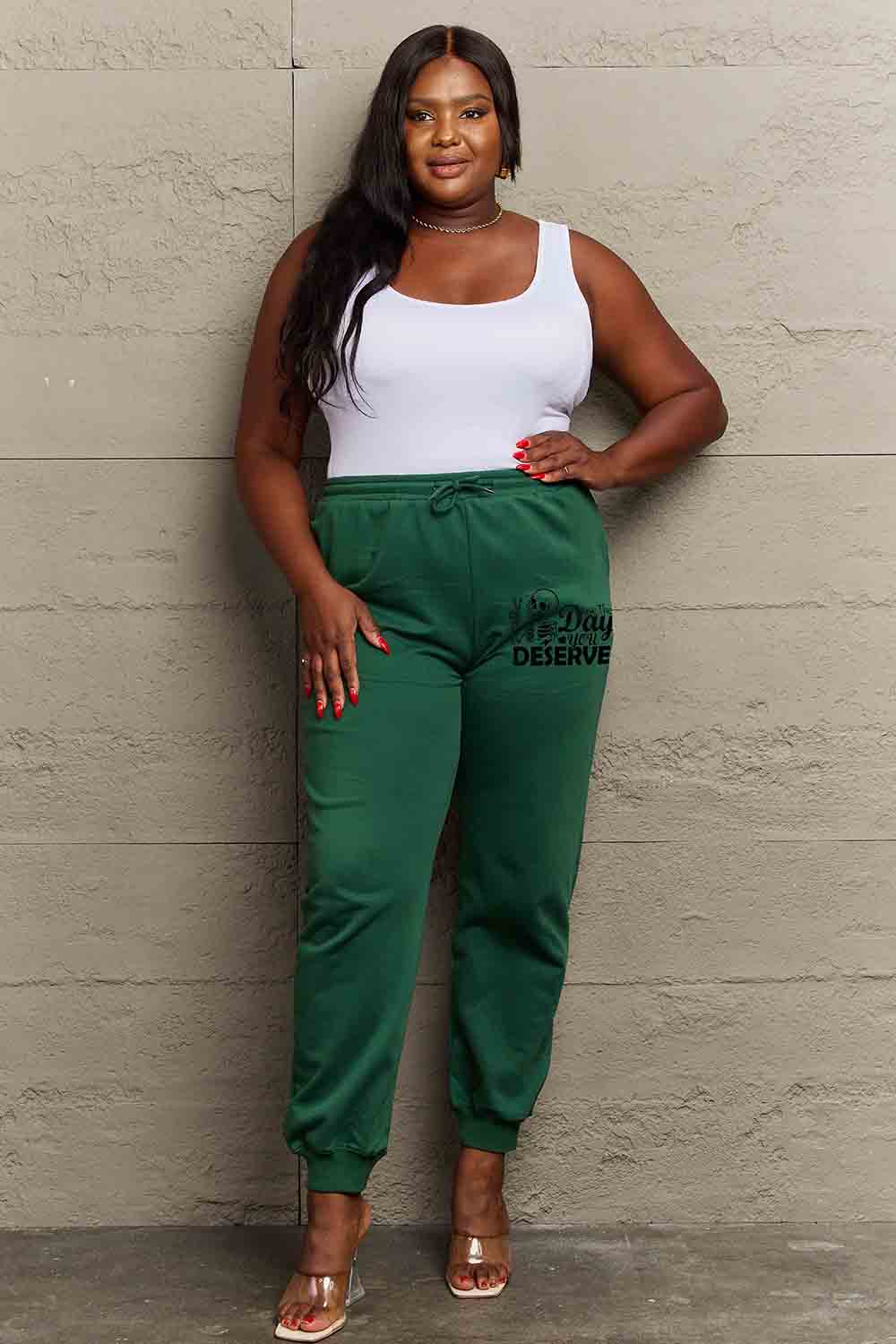 HAVE THE DAY YOU DESERVE graphic sweatpants with drawstring.