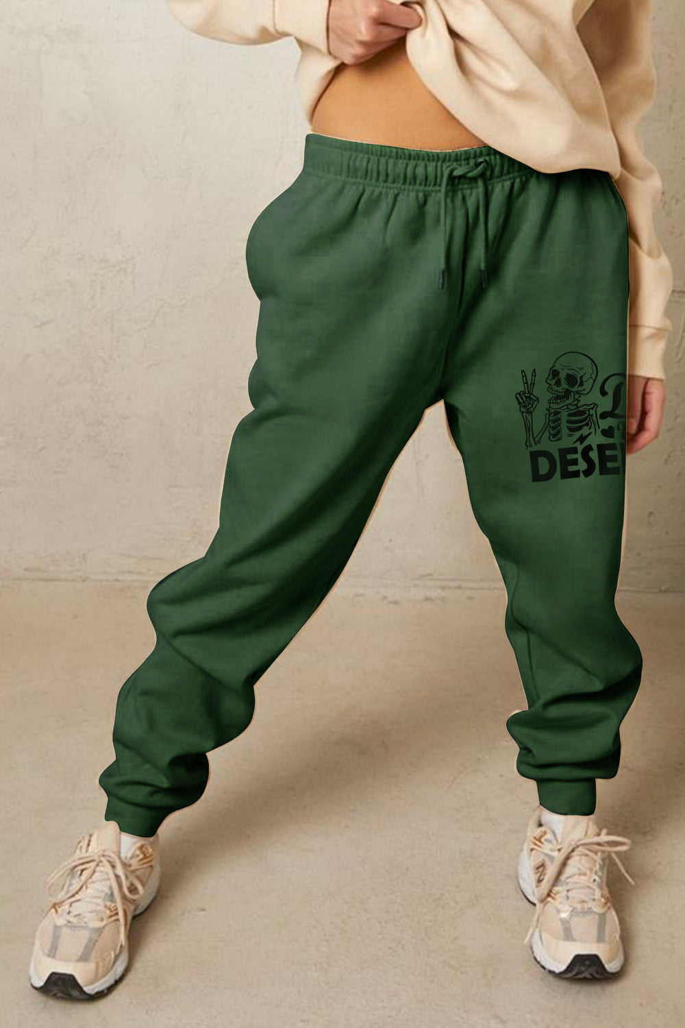 HAVE THE DAY YOU DESERVE graphic sweatpants with drawstring.