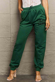 HAVE THE DAY YOU DESERVE graphic sweatpants with drawstring.