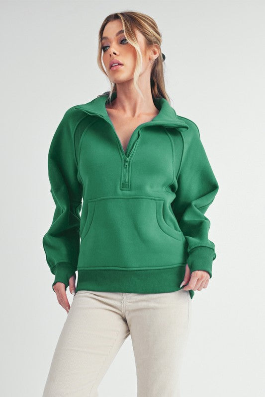 Half zip raglan sleeve sweatshirt with kangaroo pocket.