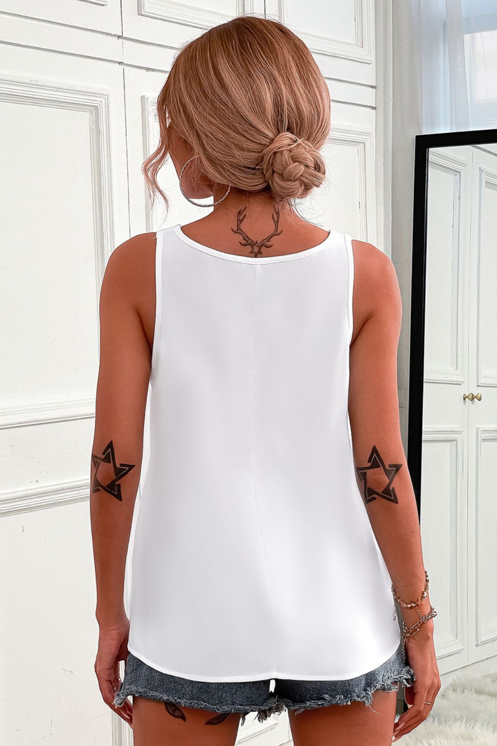 Half-zip scoop neck tank top.