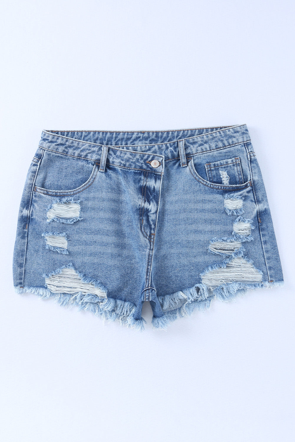 High rise crossover waist denim shorts with buttons, distressed details, and raw hem.