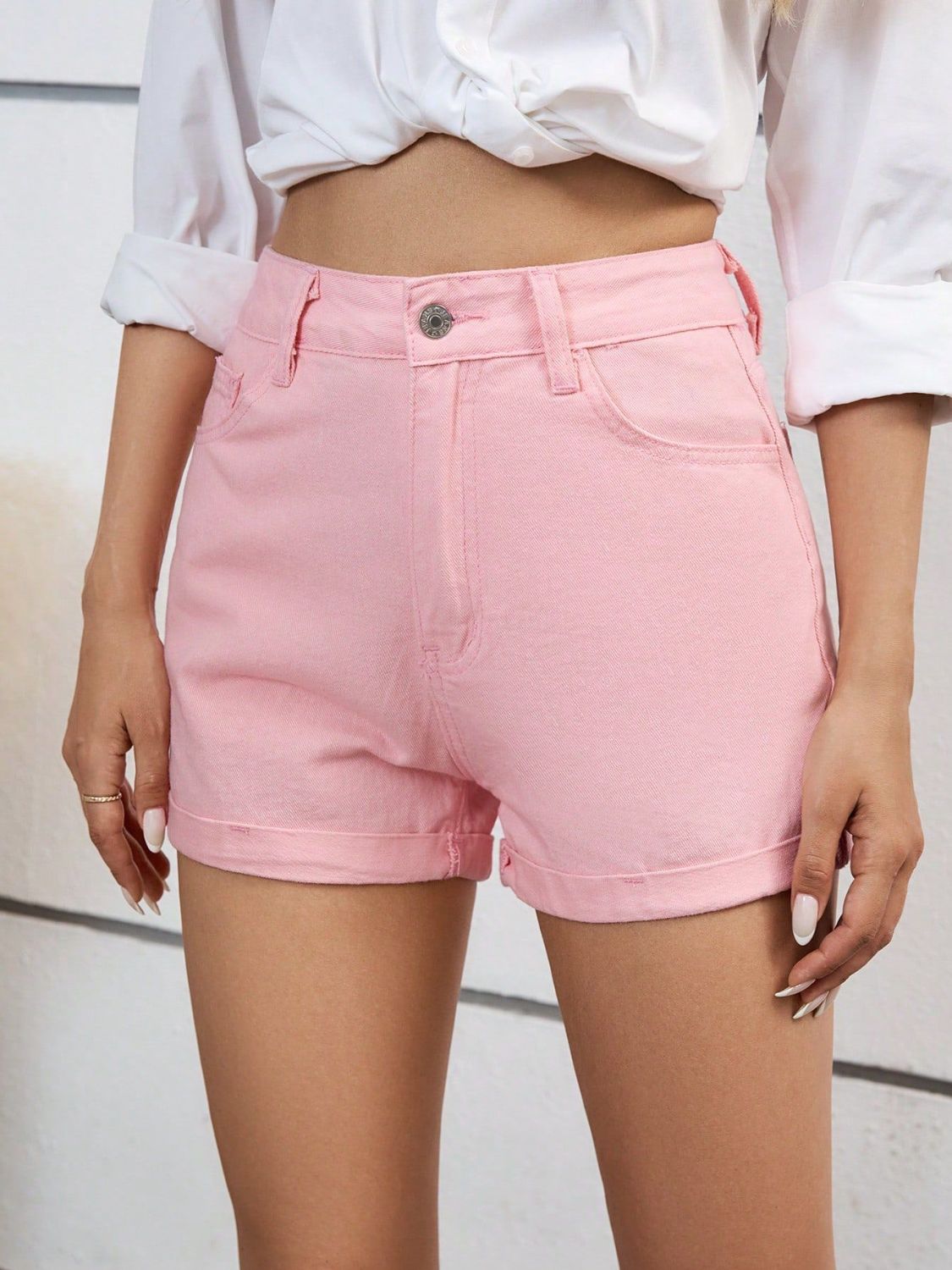 High-waist denim shorts with buttons and pockets.