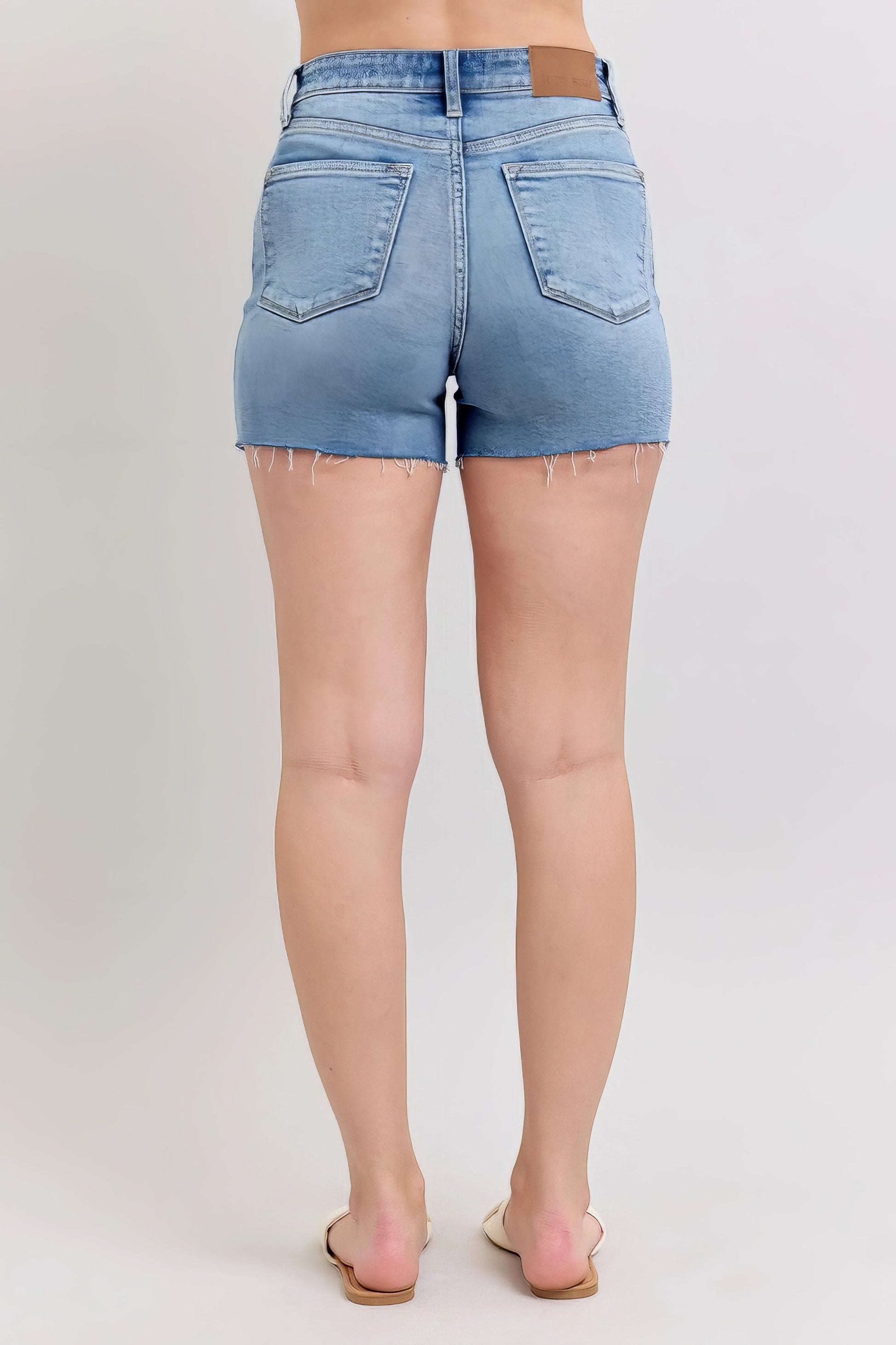 Plus size high-waist denim shorts with stitch over destroy detail and pockets.
