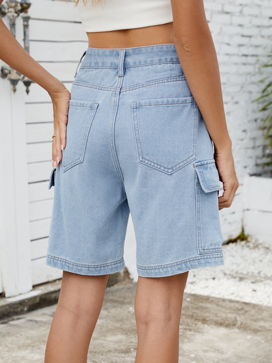 High-waist denim shorts with cargo pockets.