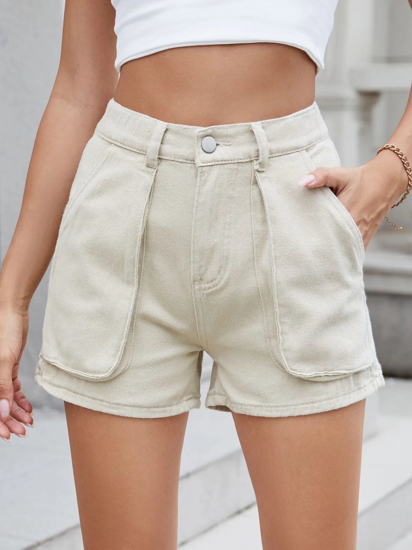 High-waist V-front Bermuda denim shorts with pockets.