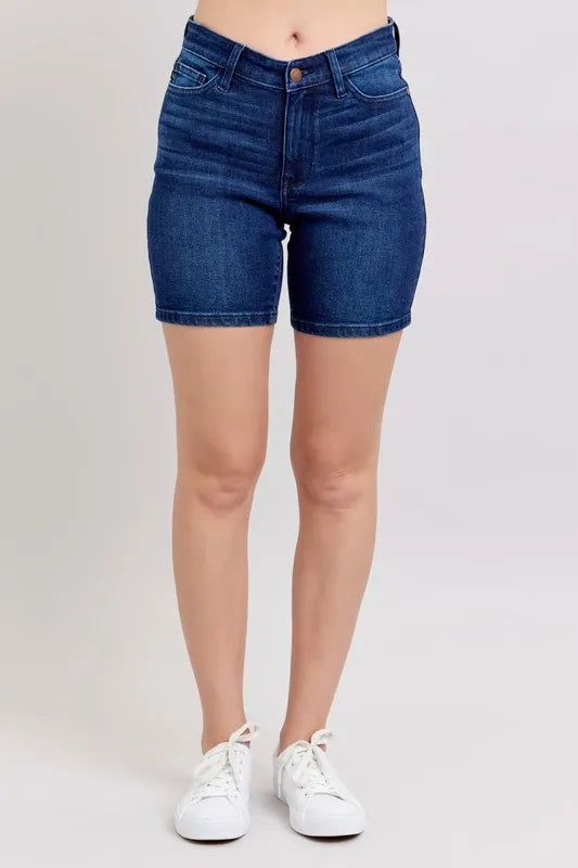 High-waist vintage wash side slit denim shorts with raw hem and pockets.