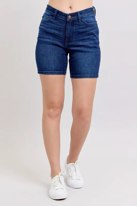 High-waist vintage wash side slit denim shorts with raw hem and pockets.