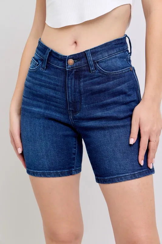 High-waist vintage wash side slit denim shorts with raw hem and pockets.