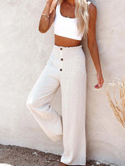 High-waisted textured wide leg pants plus size with decorative buttons.
