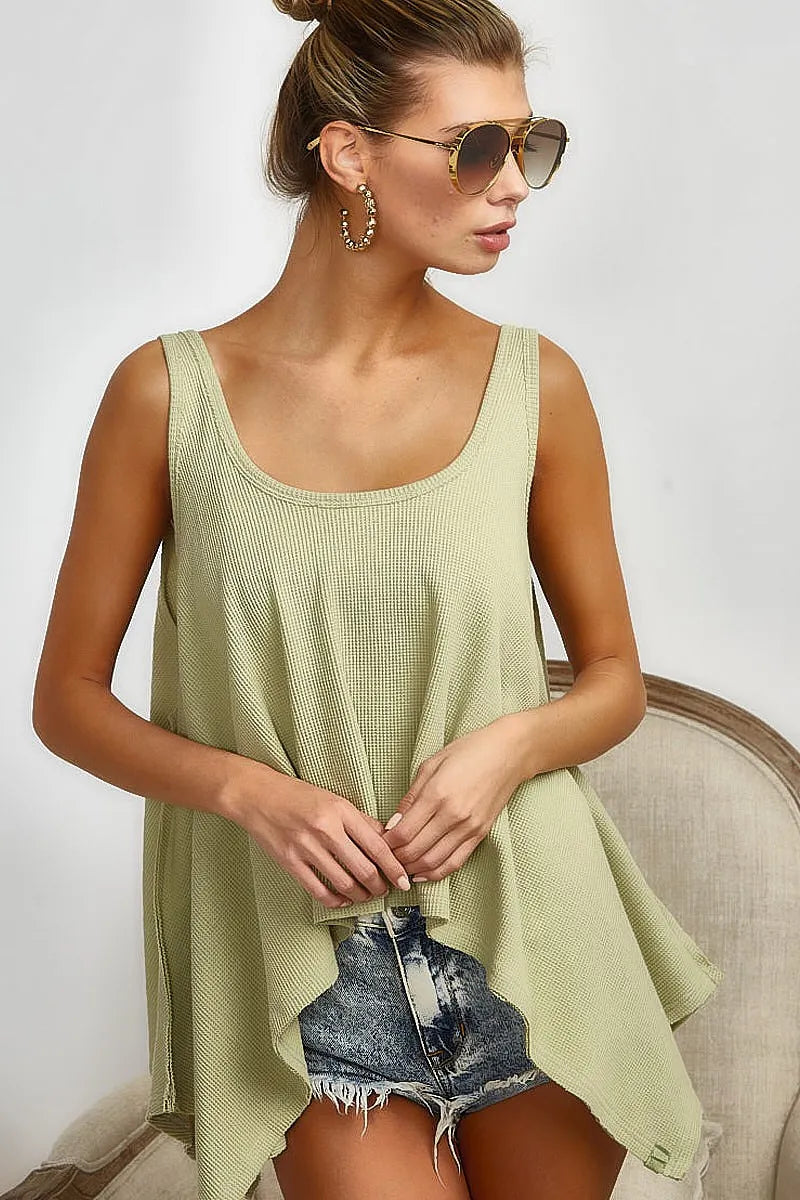 High and low flare knit tank top with oversized asymmetrical design, slightly stretchy.