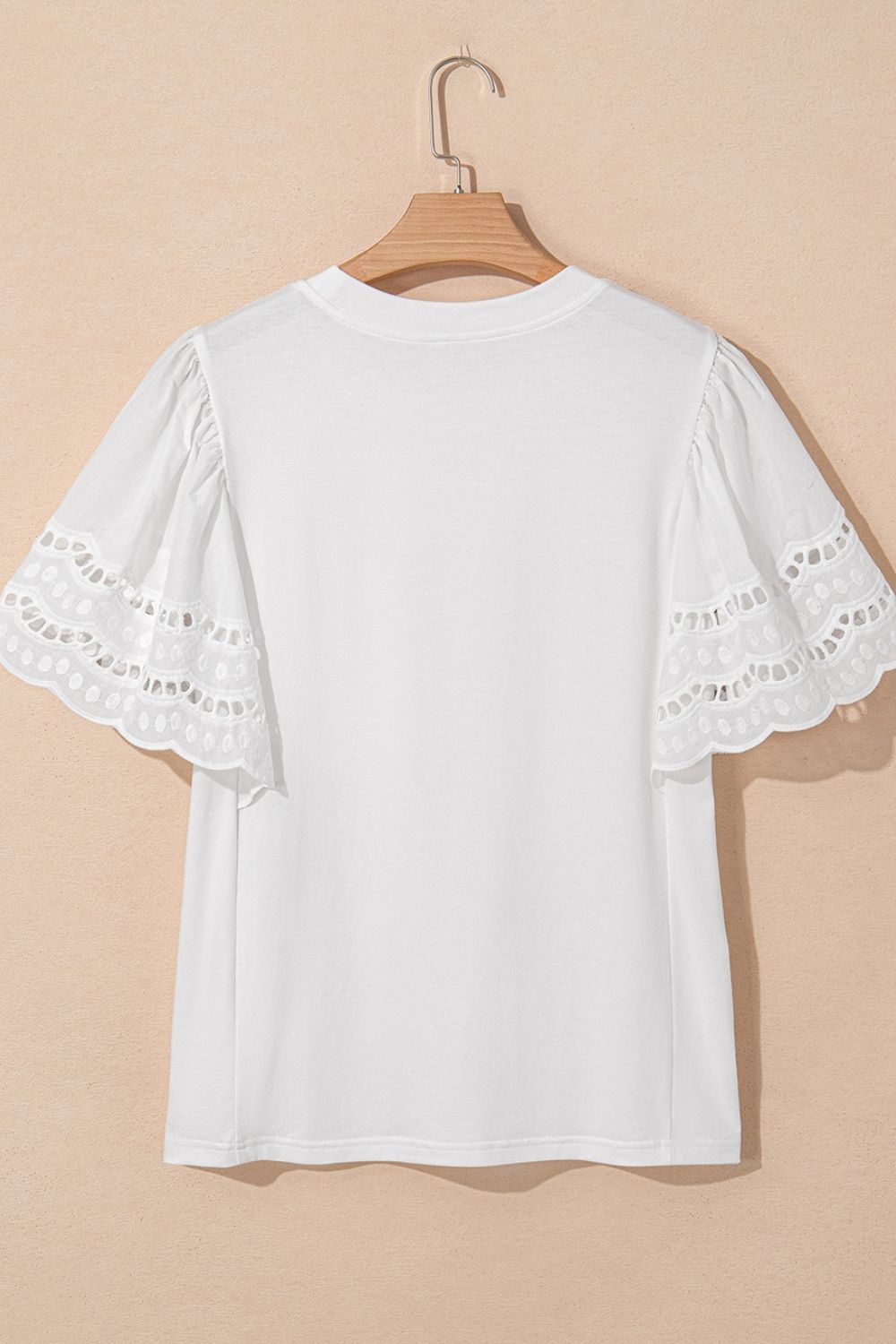 Hollow out embroidered short sleeve round neck top.